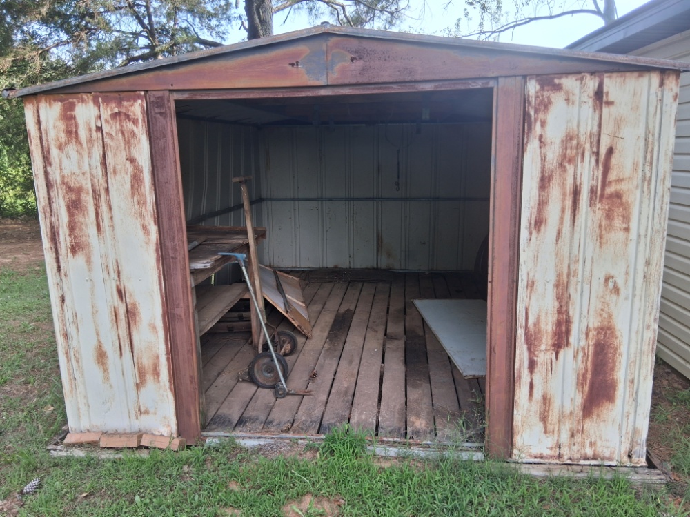Oxidized rusted metal siding before industrial coating application